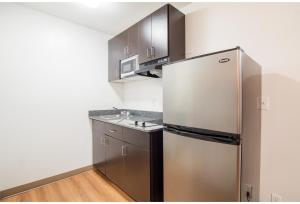 a kitchen with a stainless steel refrigerator and a sink at Studio 6 Extended Stay - Augusta, GA - Fort Gordon in Augusta