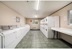 a large kitchen with white appliances in a room at Studio 6 Extended Stay - Augusta, GA - Fort Gordon in Augusta +23 photos