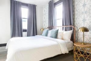 a bedroom with a white bed and a window at Inn at Gough in San Francisco