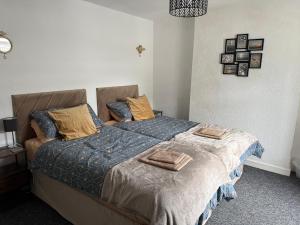 a bedroom with a bed with two pillows on it at 18 Main Street in St Bees