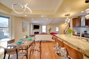 a kitchen and living room with a large counter and a table at Walk to Kinnickinnic Ave! Newly Updated Abode in Milwaukee