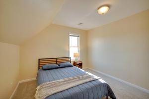 a bedroom with a bed and a window at Walk to Kinnickinnic Ave! Newly Updated Abode in Milwaukee