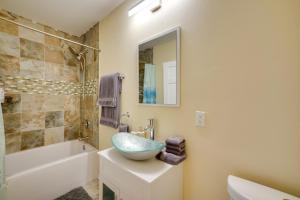 a bathroom with a bowl sink and a bath tub at Walk to Kinnickinnic Ave! Newly Updated Abode in Milwaukee +18 photos