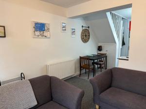 a living room with a couch and a table at 18 Main Street in St Bees