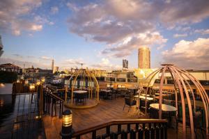 a deck with tables and chairs on a boat at YOU Nile View Hotel in Cairo