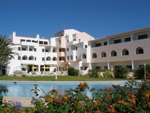 a large white building with a pool in front of it at RJ Summer in Sagres