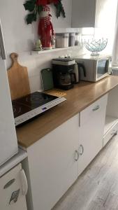 a kitchen with a counter top with a stove top oven at Sunny Hostel 49 in Wrocław +33 photos