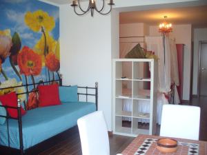a bedroom with a blue bed and a flower mural at B&B AeR in Lesina