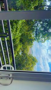 a view of the sky through a window of a tree at Villa Auxesiaa in Wattala