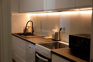 a kitchen with a sink and a stove top oven at Maison TORTONI in Bastia