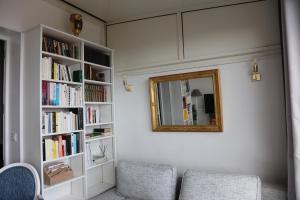 a living room with two chairs and a mirror at Maison TORTONI in Bastia