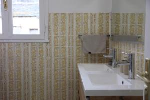 a bathroom with two sinks and a window at Maison TORTONI in Bastia