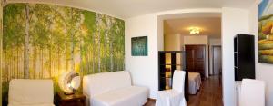 a living room with a white couch and a wall mural at B&B AeR in Lesina