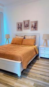 a bedroom with a large bed and two night stands at Villa Auxesiaa in Wattala +25 photos