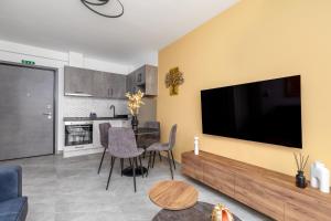a living room with a large flat screen tv at Anatoli Urban Apartment with private parking in Xanthi