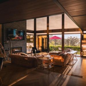 a living room with two couches and a fireplace at Casa Albarari Boutique Double Rooms with access to shared Infinity Pool in Sanxenxo