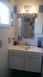 a bathroom with a sink and a mirror at Les Clés Nature Apt 44 in Moutiers-sous-Chantemerle +20 photos