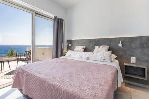 a bedroom with a large bed and a large window at Villa Anatoli in Achlia +24 photos