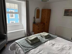 a bedroom with a bed with two pillows on it at 17 Main Street in St Bees