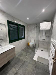 a bathroom with a shower and a toilet and a sink at Kalidoniahouses in Perapedhi +56 photos