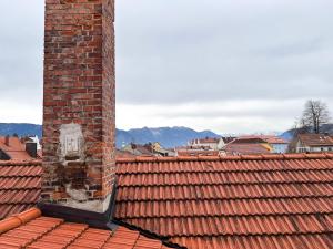a brick chimney on the roof of a city at ღLiboria Casa Mondo in Murnau am Staffelsee