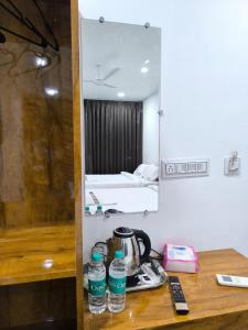two bottles of water sitting on a counter in a room at Hotel Visara Grand in Gokarna +35 photos