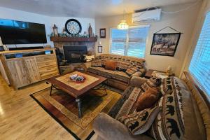 a living room with a couch and a table at Home w/ Hot Tub, 3 Mi to Lake & Ponderosa Park in McCall