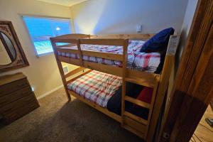 two bunk beds in a room with a window at Home w/ Hot Tub, 3 Mi to Lake & Ponderosa Park in McCall