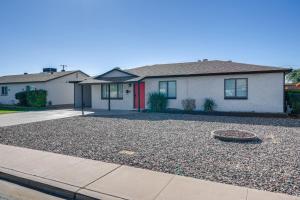 a house with a gravel driveway in front of it at Relax Poolside: Central Group Getaway in Mesa! in Mesa