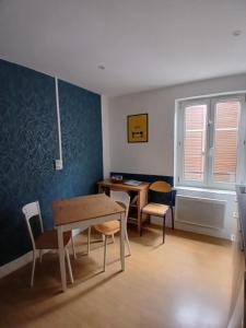 a room with a table and chairs and a table and a table and chairs at Maisonnette atypique du centre ville in Pont-à-Mousson