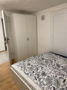 a bedroom with a bed and white cabinets at Motel Żabka in Łyse