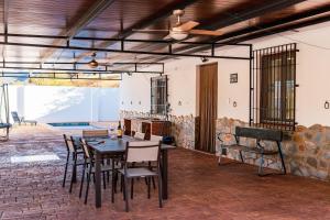 a dining room with a table and chairs at casa rural Cerro laute in Lanjarón