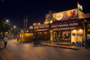 a man walking down a street at night at Hotel Hare Krishna & Banquet, Vrindavan in Vrindāvan