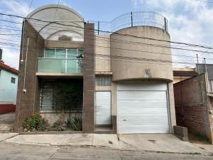 a building with two garage doors in front of it at La Casa de Ikal Zacatlán in Zacatlán