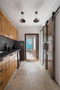 a kitchen with a door leading to a dining room at אי שם בגולן in Keshet