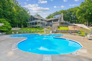 a large swimming pool in front of a house at Cozy Days Hideaway - Modern rustic vibes mountain views in Jasper