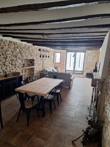 a dining room with a table and a couch at Casa Trilles in Azuébar +45 photos