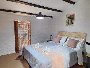a bedroom with a large bed with two towels on it at Casa Trilles in Azuébar