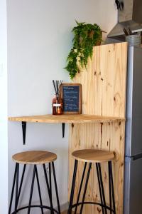 a kitchen counter with two stools and a table at Pause Pedal Pyrénées in Capvern