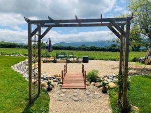 a wooden bench in the middle of a garden at Pause Pedal Pyrénées in Capvern
