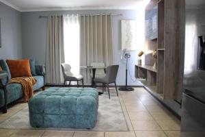 a living room with a couch and a table at Stonewall Luxury Apartment in Northriding