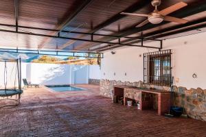 an open living room with a stone fireplace and a ceiling at casa rural Cerro laute in Lanjarón