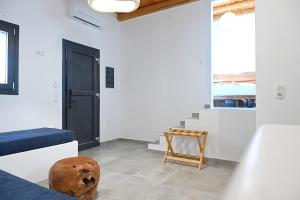 a living room with a couch and a table at Alkyoni Celeste Kythnos in Kithnos