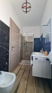 a bathroom with a shower and a sink and a tub at B&B Le Tre Vette in Scoppito