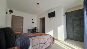 a bedroom with a bed and a tv on the wall at B&B Le Tre Vette in Scoppito