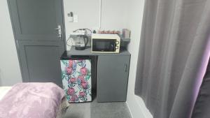 a room with a bed and a microwave on a table at Sand Fontein in Springbok