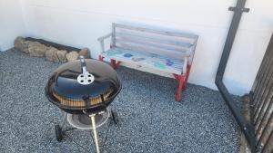a charcoal grill and a bench in a room at Sand Fontein in Springbok