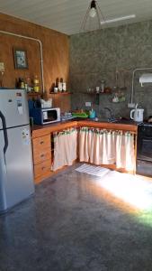 a kitchen with a white refrigerator and a sink at Los Eucaliptos in Duggan +15 photos
