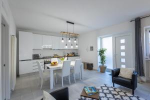 a kitchen and living room with a table and chairs at LAKE COMO BORGO VIGNOLA - Cozy Apartment in a Charming Village in Cremia