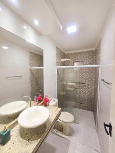 a bathroom with a sink and a toilet and a shower at Casa dos Carvalhos in Piranhas +9 photos